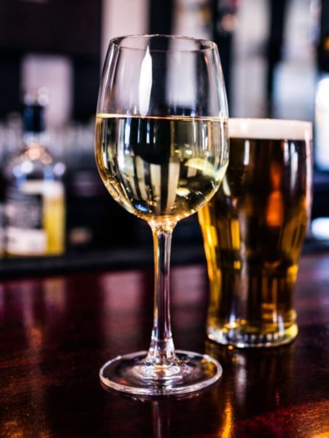 Close up of a glass of wine and a beer in a bar